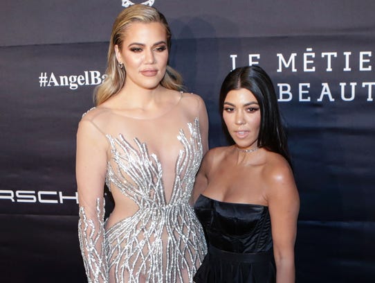 Khloe Kardashian (left) and Kourtney Kardashian attend