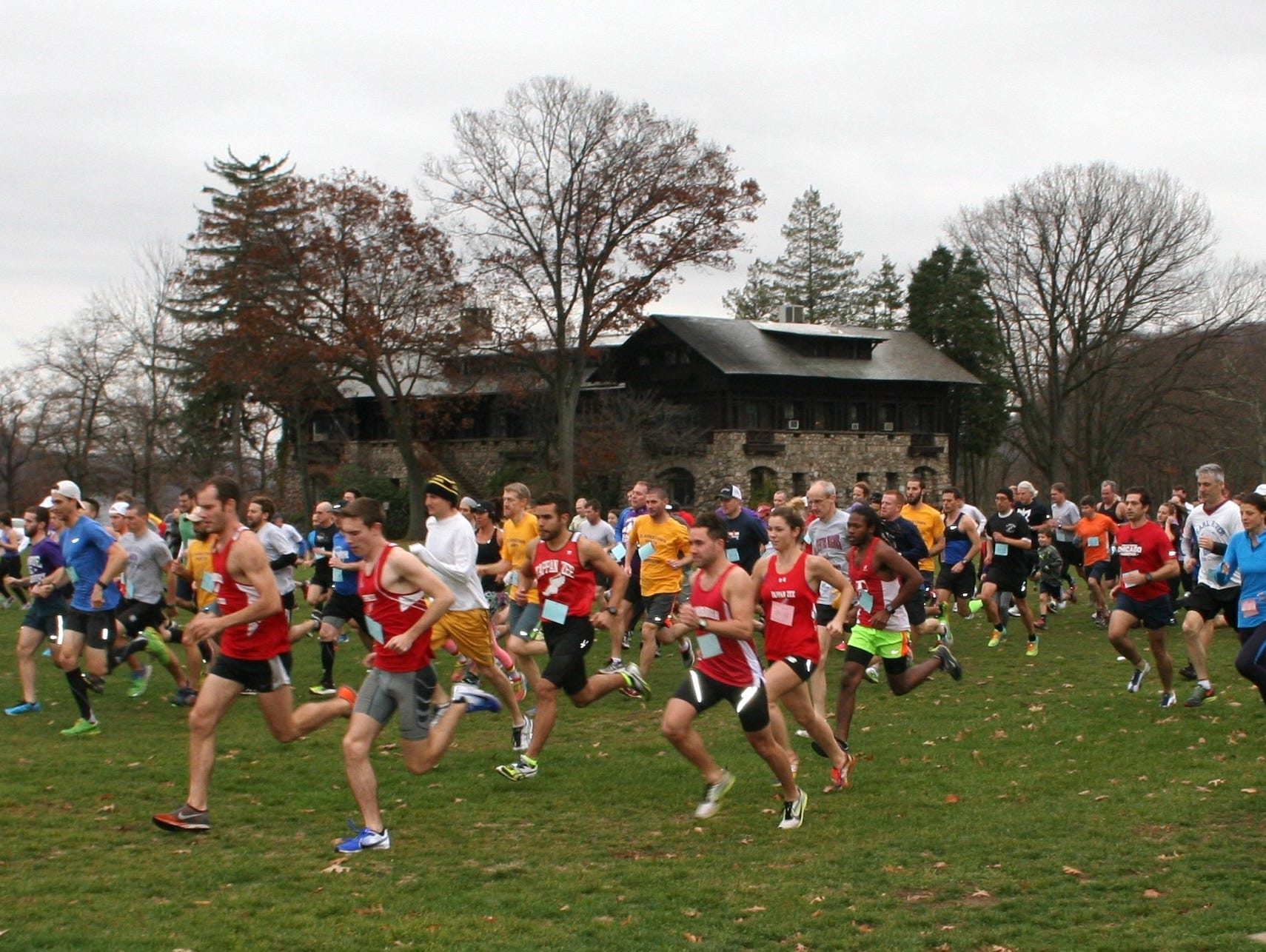 Runners in the Rockland Alumni Cross Country meet take off from the starting line at Bear Mountain State Park.