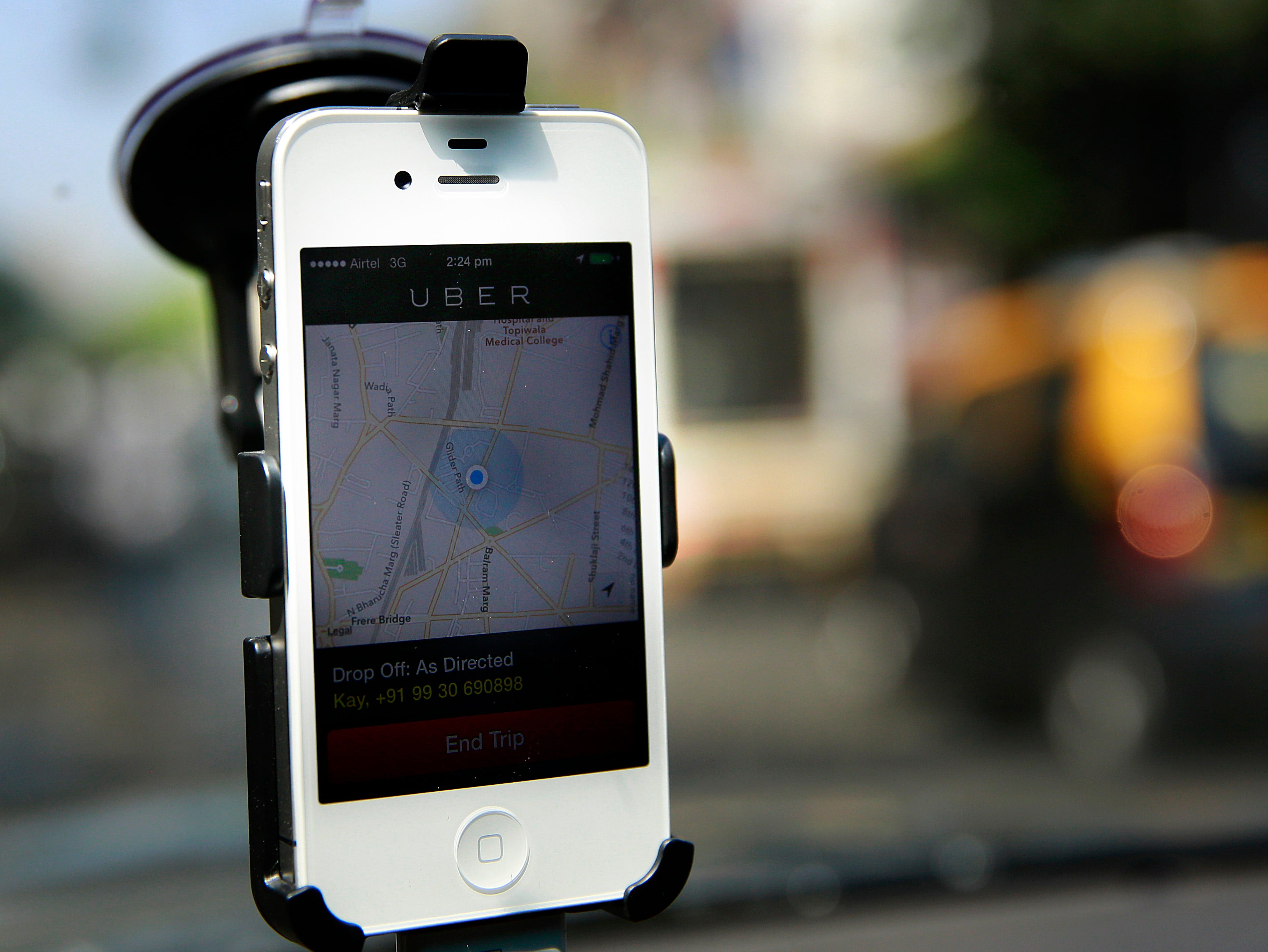A smartphone is mounted on the glass of an Uber car in Mumbai, India, on April 3, 2013.