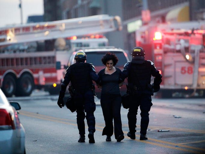 A protester is detained by police in Baltimore. 