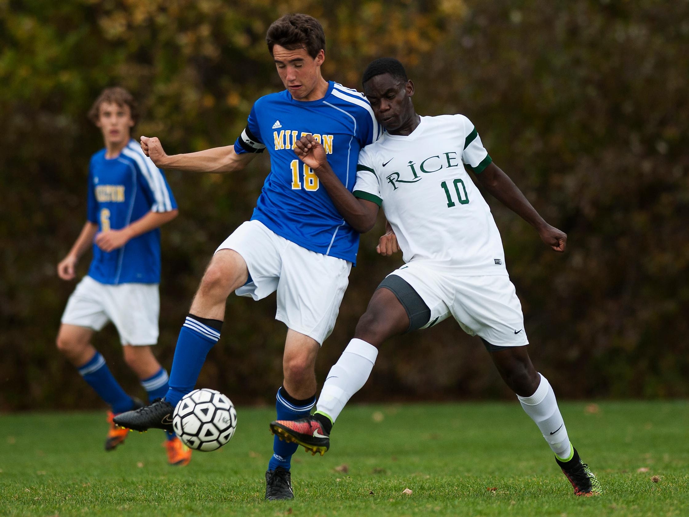 Rice's Hussein Hussein (10) battles for the ball with Milton's Eric Menard (18) during the boys varsity soccer game between the Milton Yellow Jackets and the Rice Green Knights at Rice High School on Wednesday October 15, 2014 in South Burlington, Vermont. (BRIAN JENKINS, for the Free Press)