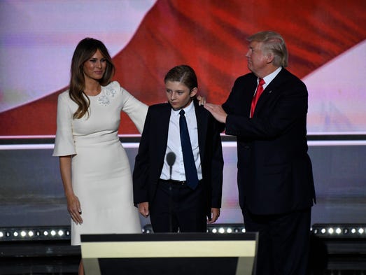 Donald Trump stands with his wife, Melania, and son