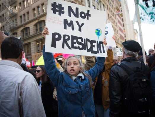 Thousands of protesters march up Fifth Avenue to Trump