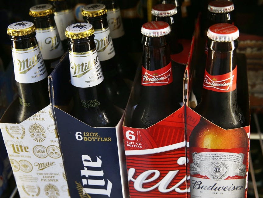 Bottles of Budweiser and Miller Lite beer are seen on Sept. 16, 2015, in Miami, Florida. Budweiser and Miller Lite are owned by Belgium's Anheuser-Busch InBev.