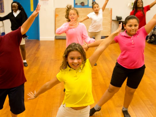 Gabriella Castro, 9, center, practices a Christmas