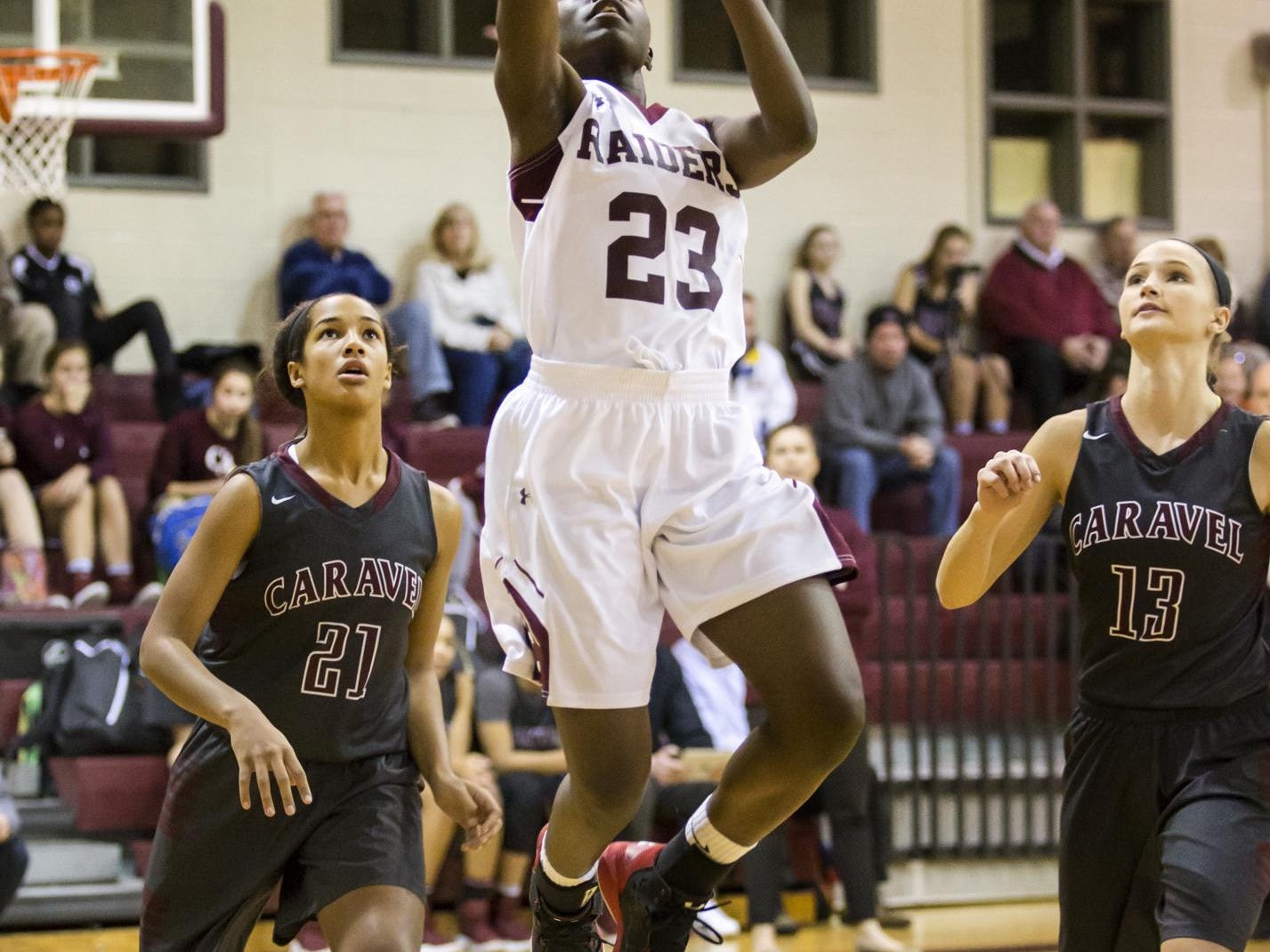 Concord's Zhan'e Snow (No. 23) puts up a shot between Caravel's Kaylee Otlowski (No. 21) and Grace Lange (No. 13) in the first half of Caravel's 42-26 win over Concord at Concord High School on Monday night.