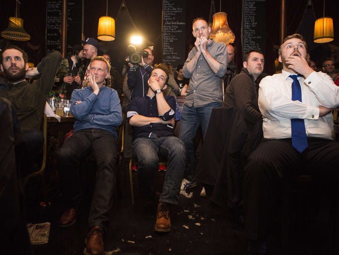 People watch election returns, in a London pub,  announcing