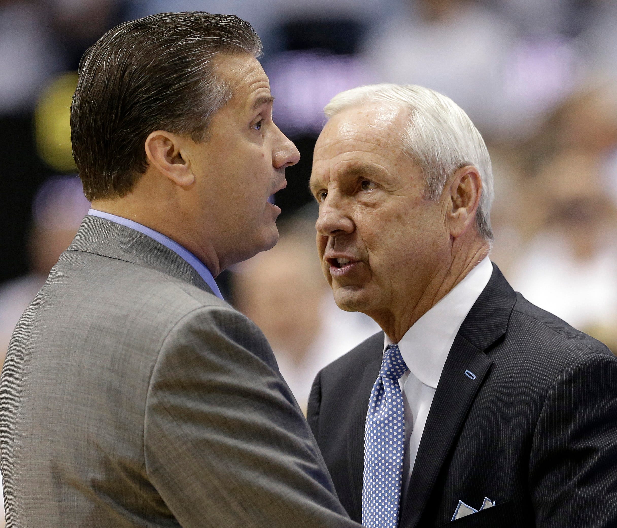 Kentucky coach John Calipari, left, and North Carolina coach Roy Williams speak before an NCAA college basketball game in Chapel Hill, N.C., Saturday, Dec. 14, 2013. (AP Photo/Gerry Broome)