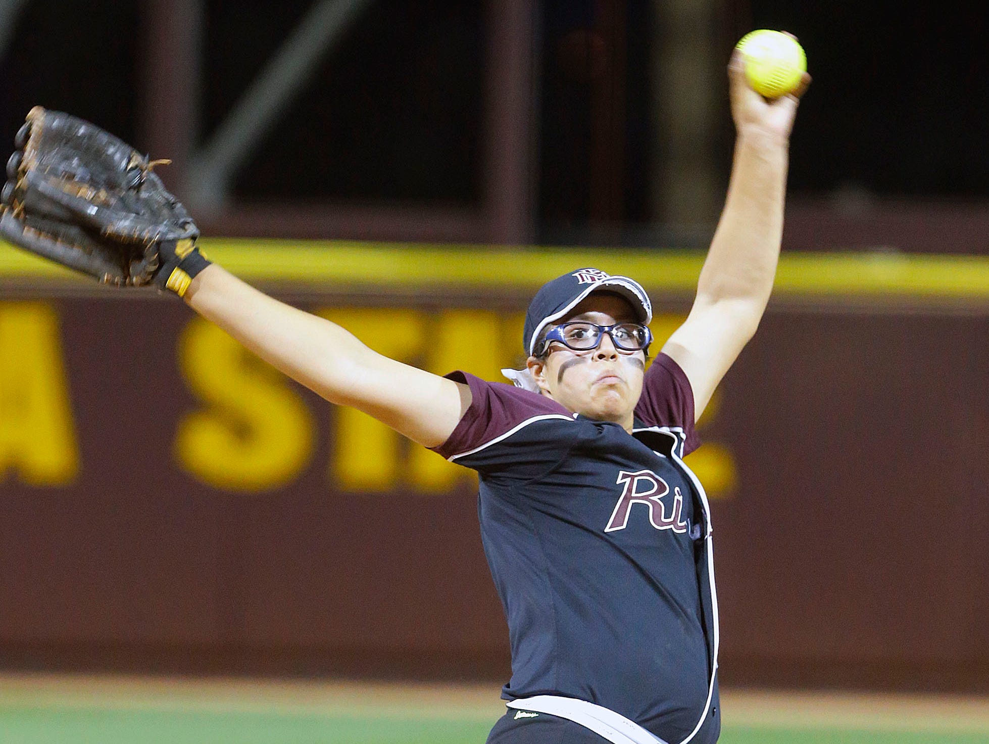 Glendale Mountain Ridge pitcher Giselle Juarez throws against Red Mountain in their 8-1 loss to Mountain Ridge in the Division I state championship Monday, May 19, 2014 in Tempe.