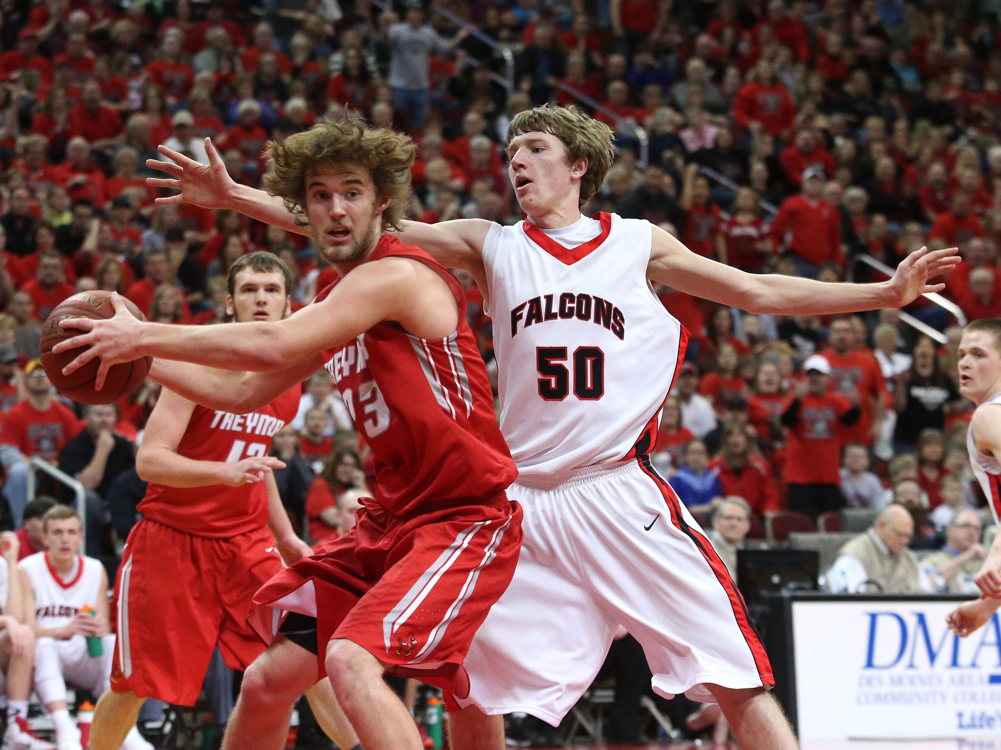 Treynor senior Trey Robinson looks to escape from the defense of Aplington-Parkersburg junior CJ May in a Class 2-A semifinal on Thursday. Robinson scored a team-high 16 points and grabbed 13 boards.