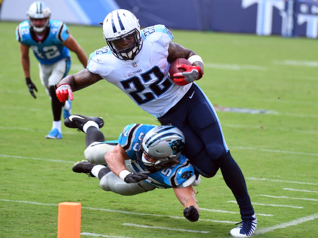 Tennessee Titans running back Derrick Henry is knocked out of bounds by Carolina Panthers linebacker David Mayo  during the first half at Nissan Stadium in Nashville.