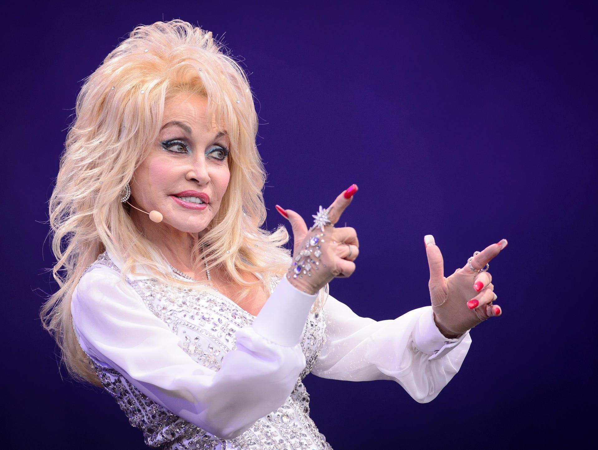 US country music singer Dolly Parton performs on the Pyramid Stage, on the final day of the Glastonbury Festival of Music and Performing Arts on Worthy Farm in Somerset, southwest England, on June 29, 2014. AFP PHOTO / LEON NEAL (Photo credit should read LEON NEAL/AFP/Getty Images)