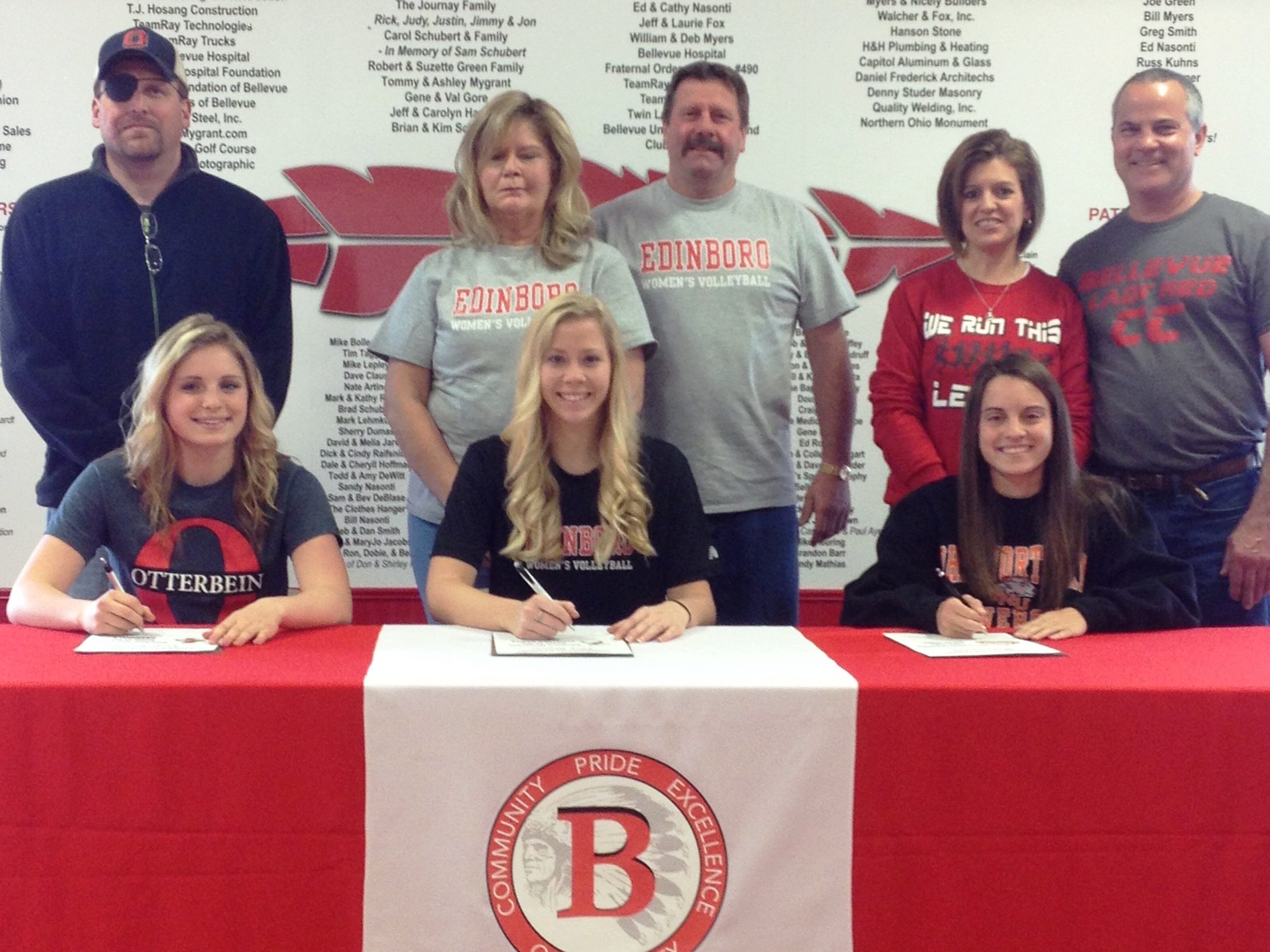 Bellevue High School seniors Sarah Bedell (front row, left) Tare Rinner (front center) and Michaela Fox (front right) sign to continue their athletic careers at the collegiate level Thursday. Bedell will run track at Otterbein University, Rinner will play volleyball at Edinboro University of Pennsylvania and Fox will run cross county at Ohio Northern. Submitted photo
