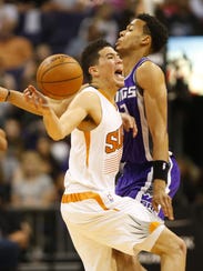 Phoenix Suns guard Devin Booker (1) is fouled by Sacramento