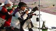 Competitors shoot during men's 50-meter rifle 3 positions