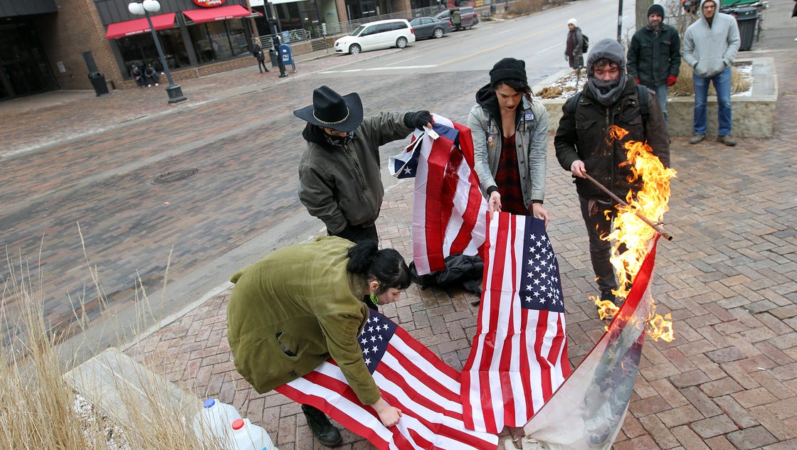 the burning of the american flag by prostesters Ferguson demonstrators set fire to american flag outside protesters in ferguson have set an american flag ablaze in number held the burning flag. the burning of the american flag by prostesters Ferguson demonstrators set fire to american flag outside protesters in ferguson have set an american flag ablaze in number held the burning flag.