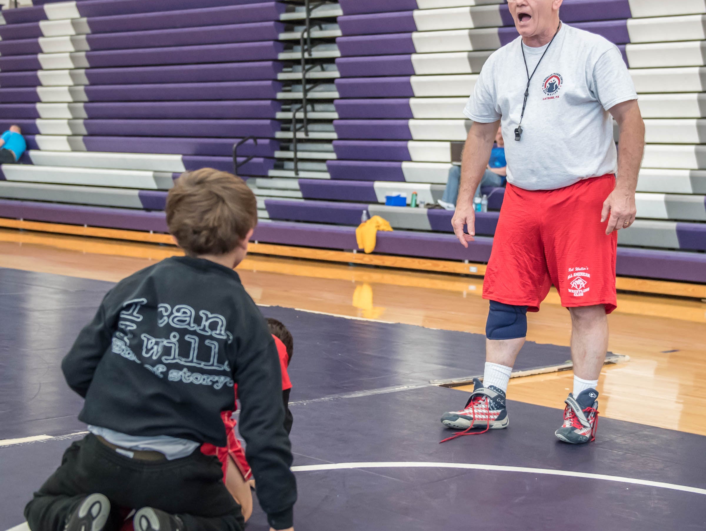 Rob Waller works with kids at Rob Waller's All-American Wrestling Camps at Lakeview High School on Wednesday.