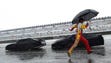 Clint Bowyer tries to dodge the rain on pit road at Pocono Raceway on Aug. 7, 2011.