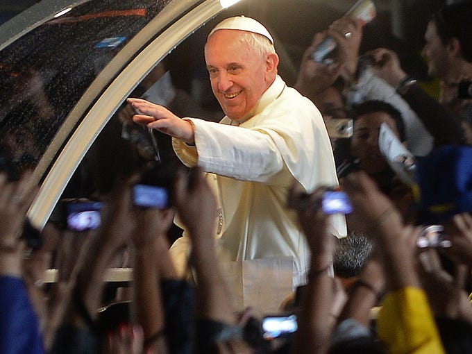 Pope Francis waves to the crowd as he leaves the Cathedral of St. Sebastian on July 27 in Rio de Janeiro, Brazil.