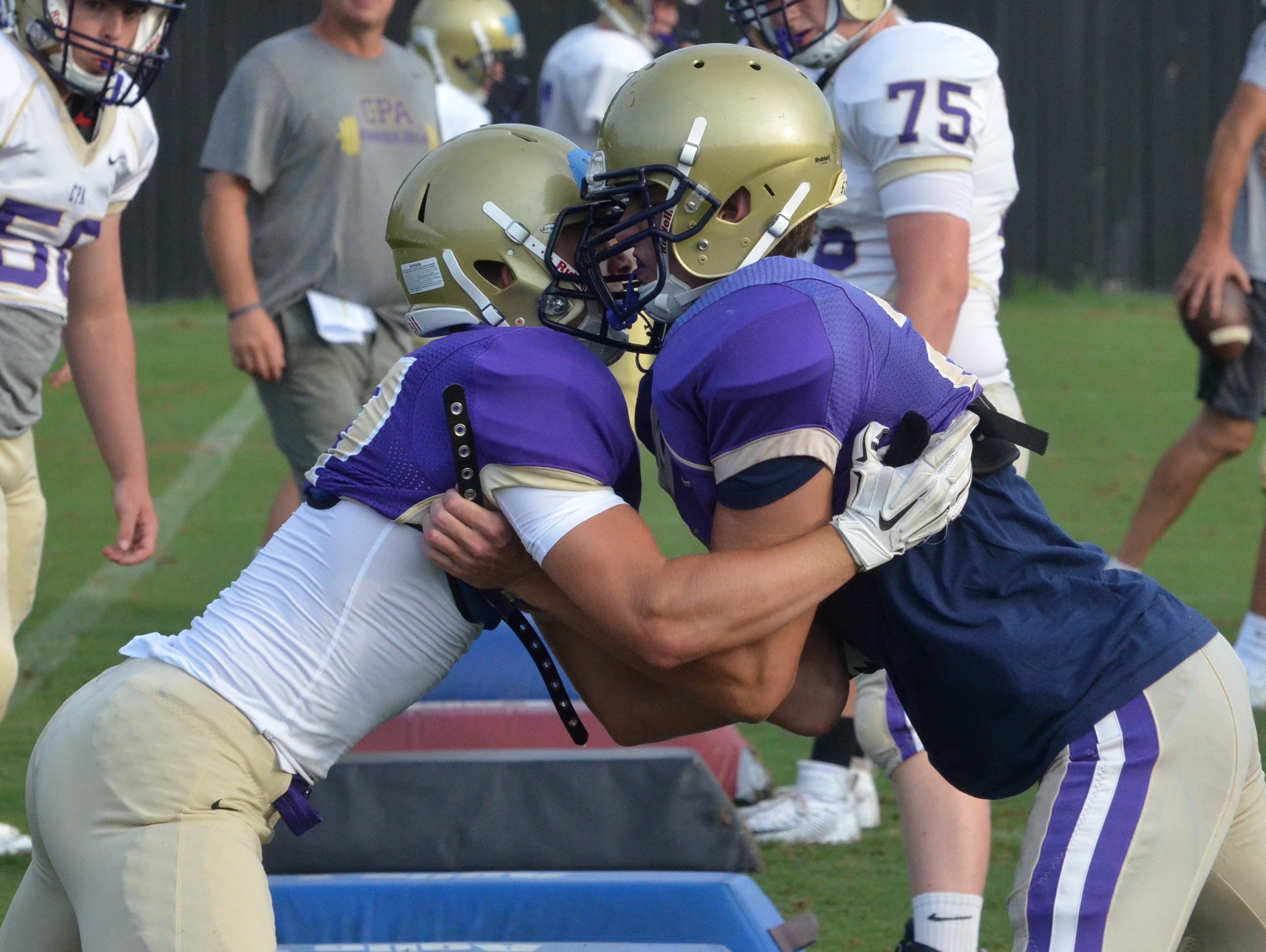 Christ Presbyterian Academy players participate in the first full-contact drills of the season on Monday morning.