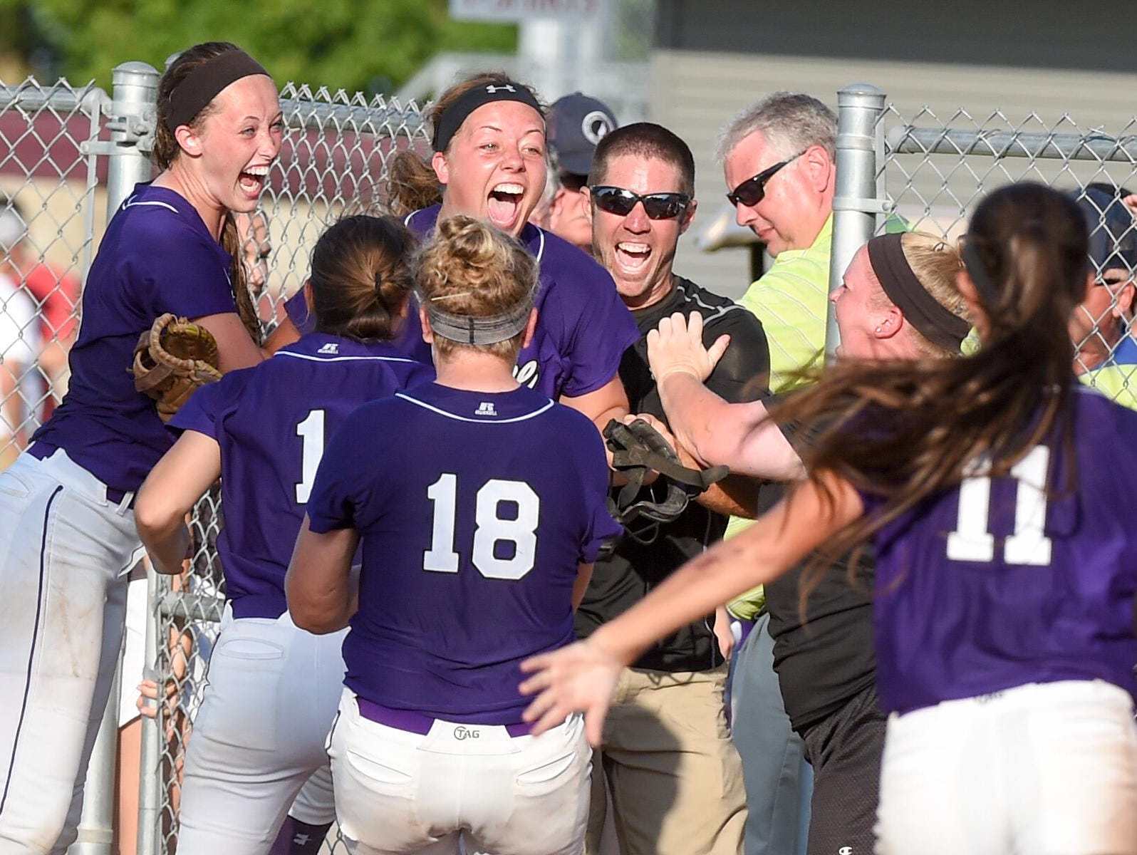 Waukee players and coaches celebrate after the Warriors won the Class 5-A state softball title.
