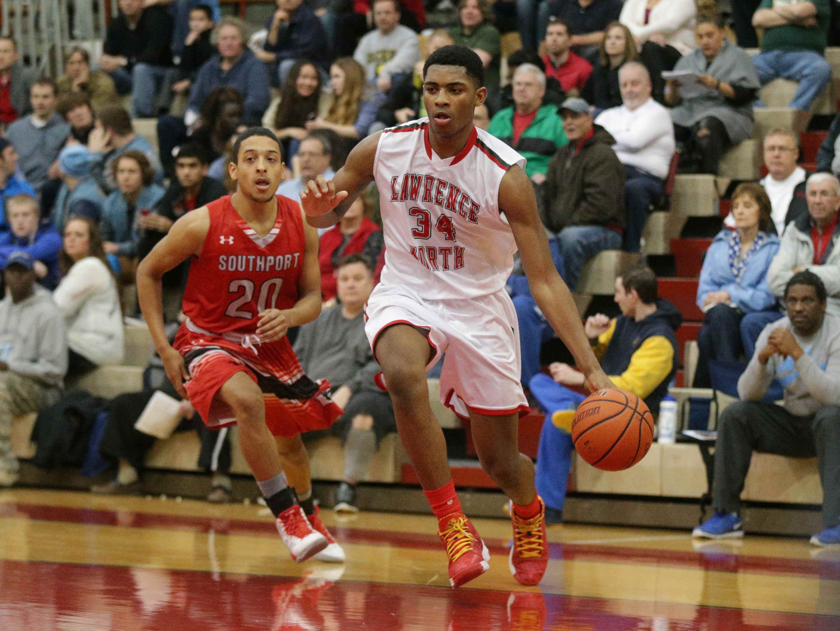Lawrence North High School sophomore Kevin Easley Jr., shown driving against Southport's David Reyes during a Marion County Boys Basketball Tournament semifinal, is learning a new position and still adjusting to life without his mom.