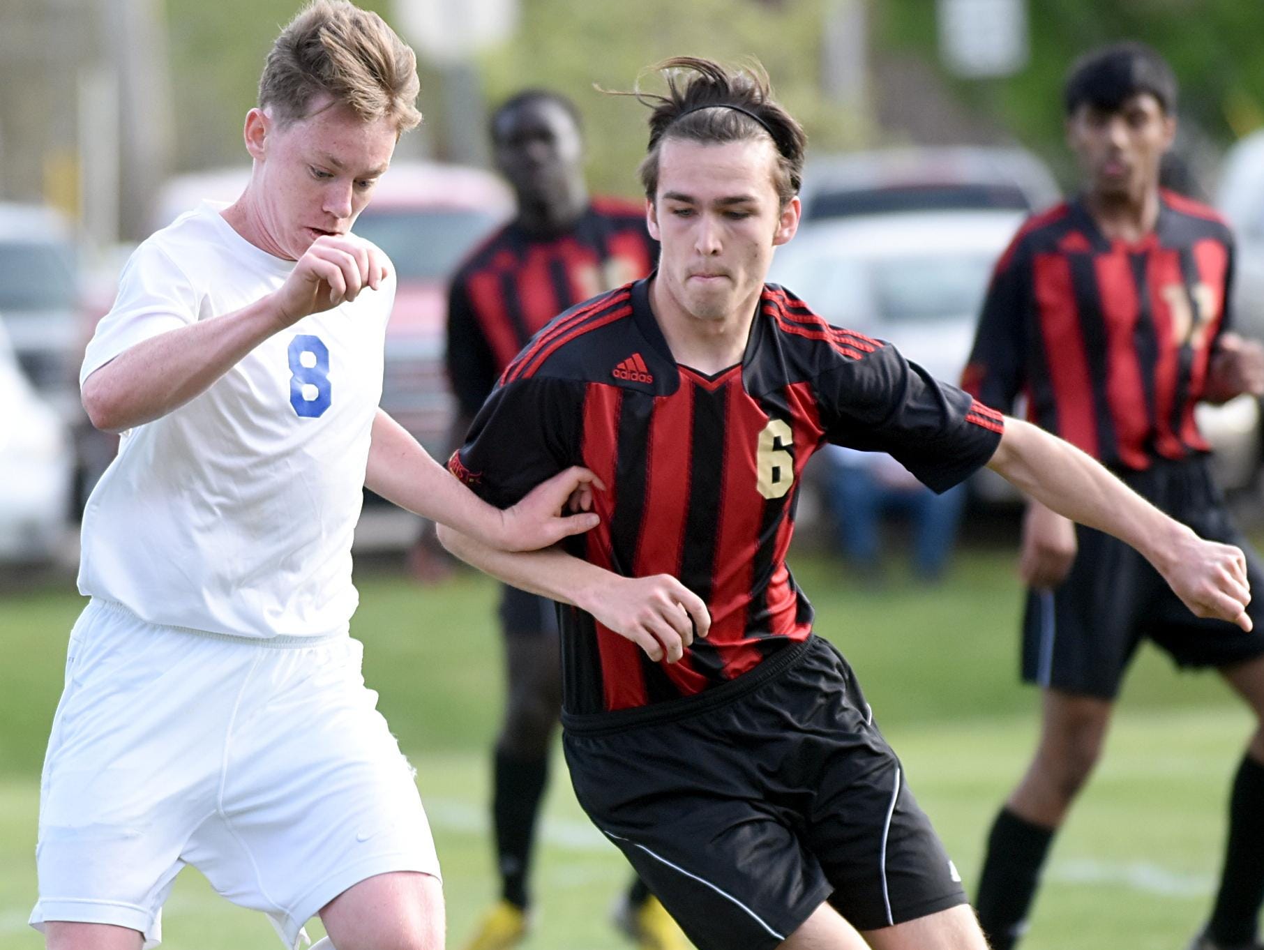 White House High junior Austin Blansett maintains possession amidst pressure from Rossview senior Jared Stanford during first-half action.