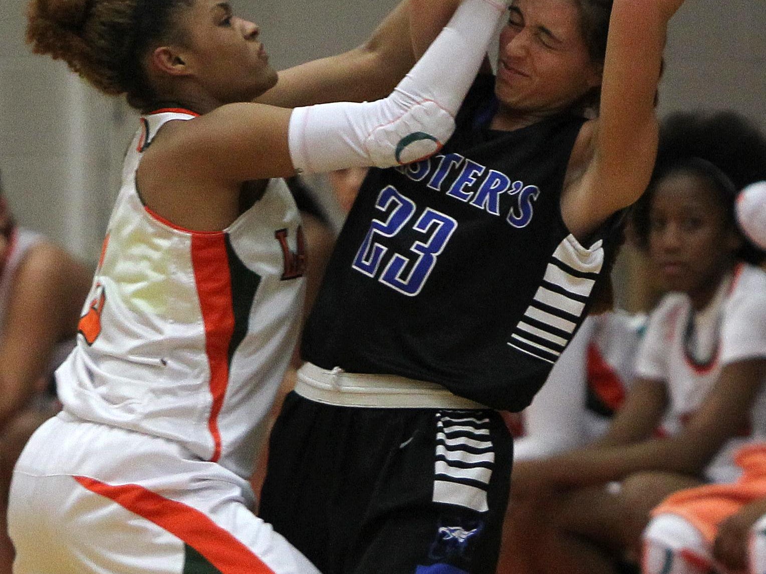 Dunbar’s Syanna Brown, left, takes the ball away from The Master's Academy player Jasmine Tuttobene during the Queen of Palms tournament in Fort Myers on Tuesday.