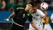 Mexico's Alan Pulido (9) heads the ball away fro New