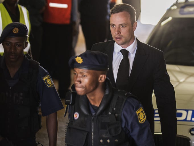 CORRECTS TO LEAVING Oscar Pistorius (C) is escorted