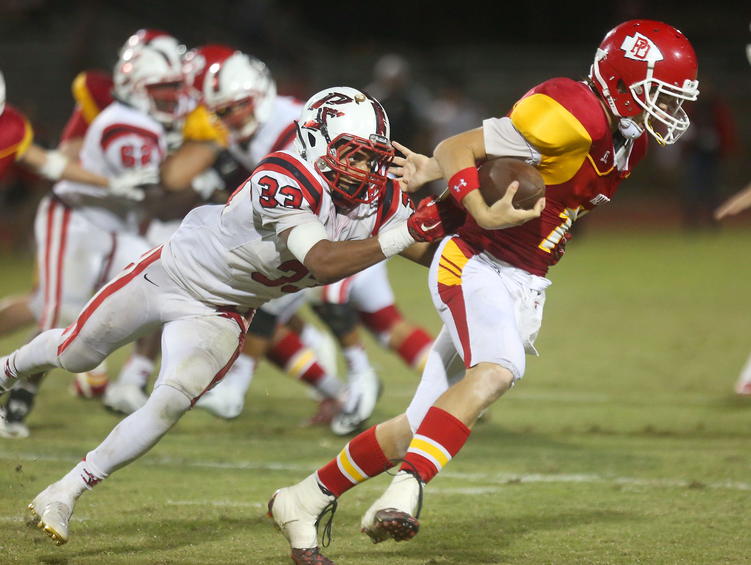 Joshua Barlow of Palm Springs sacks Palm Desert quarterback Brian Devlin in the fourth quarter, Friday, October 23, 2015..