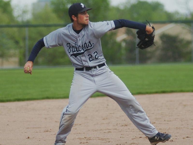 Senior third baseman Ravi Mahanti makes the throw to first base after fielding a ground ball.