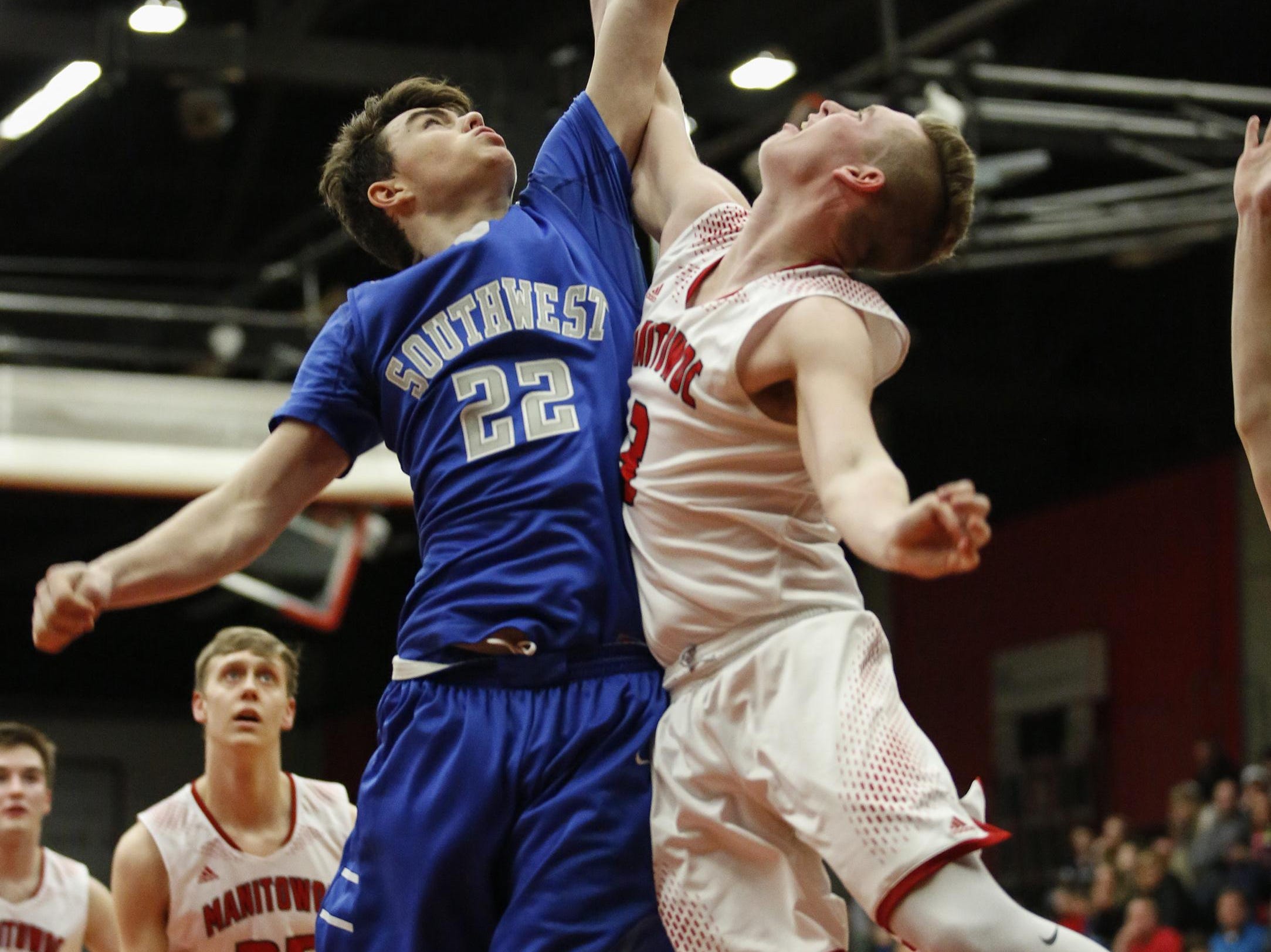 Green Bay Southwest’s Cole Bouche swats the shot of Manitowoc’s Braedon Bandt in a boys basketball game Friday in Manty.