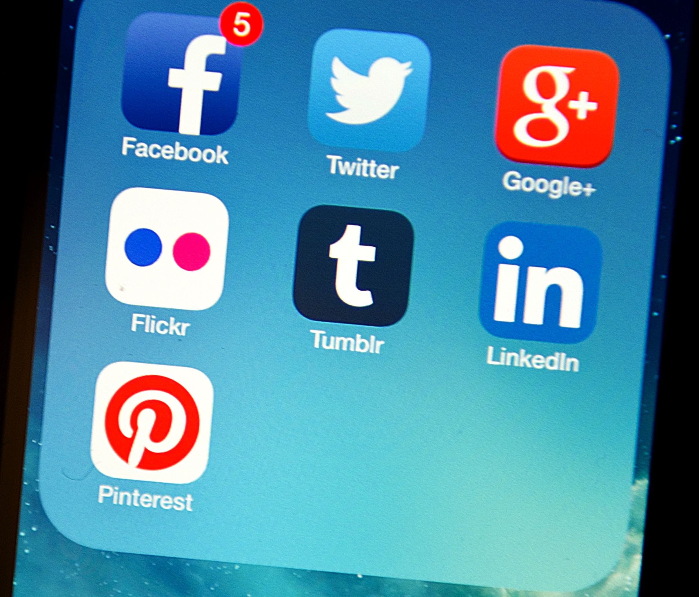 Social media apps appear on an Apple iPhone 5s.