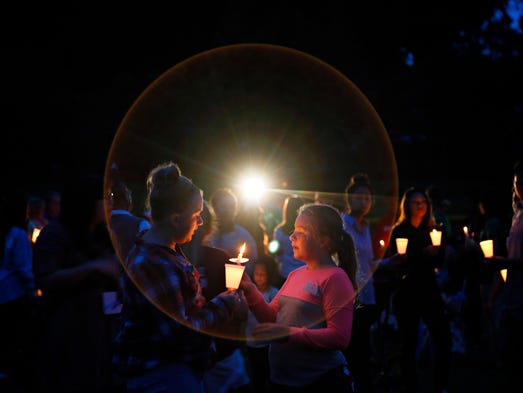 Kaylee Wood, 13 lights a candle for Emma Hoops, 10,