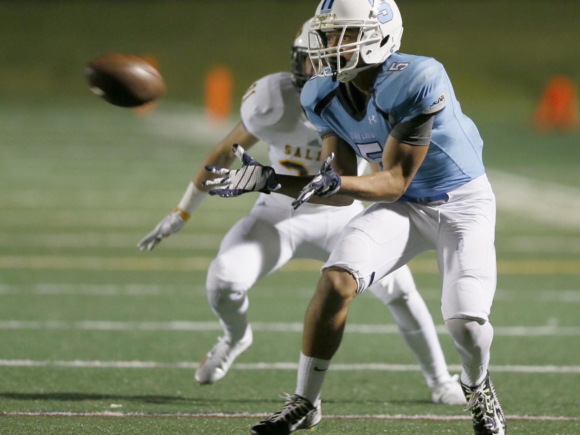 Ann Arbor Skyline high school's Hunter Rison catches a pass in the third quarter of their football game against Saline on Friday, September 11, 2015, in Ann Arbor. Julian H. Gonzalez/Detroit Free Press