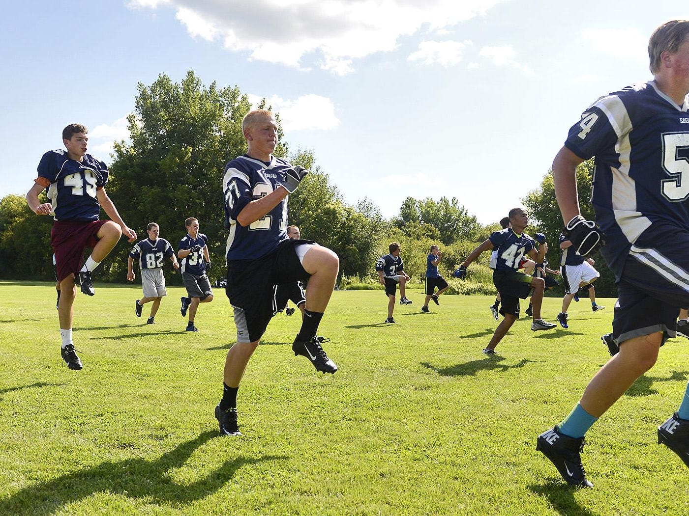 Eden Valley-Watkins players stretch and leap during warmups for practice Aug. 11 in Eden Valley.