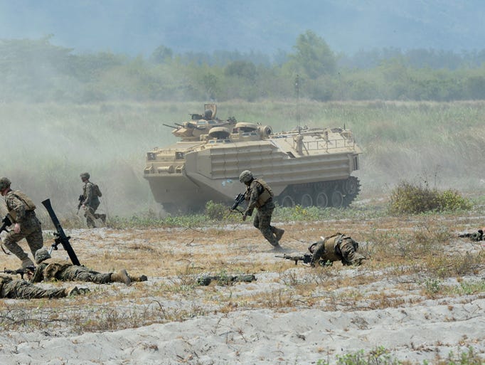 U.S. Marines take positions with mortars and an amphibious