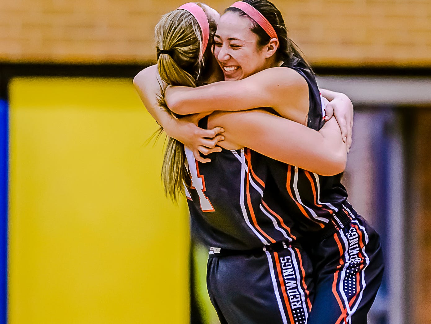 Erika Ballinger ,right, and Brooke Mazzolini of St. Johns hug after their Class A regional final win over Saginaw Heritage Thursday March 10, 2016 at Midland High in Midland. KEVIN W. FOWLER PHOTO