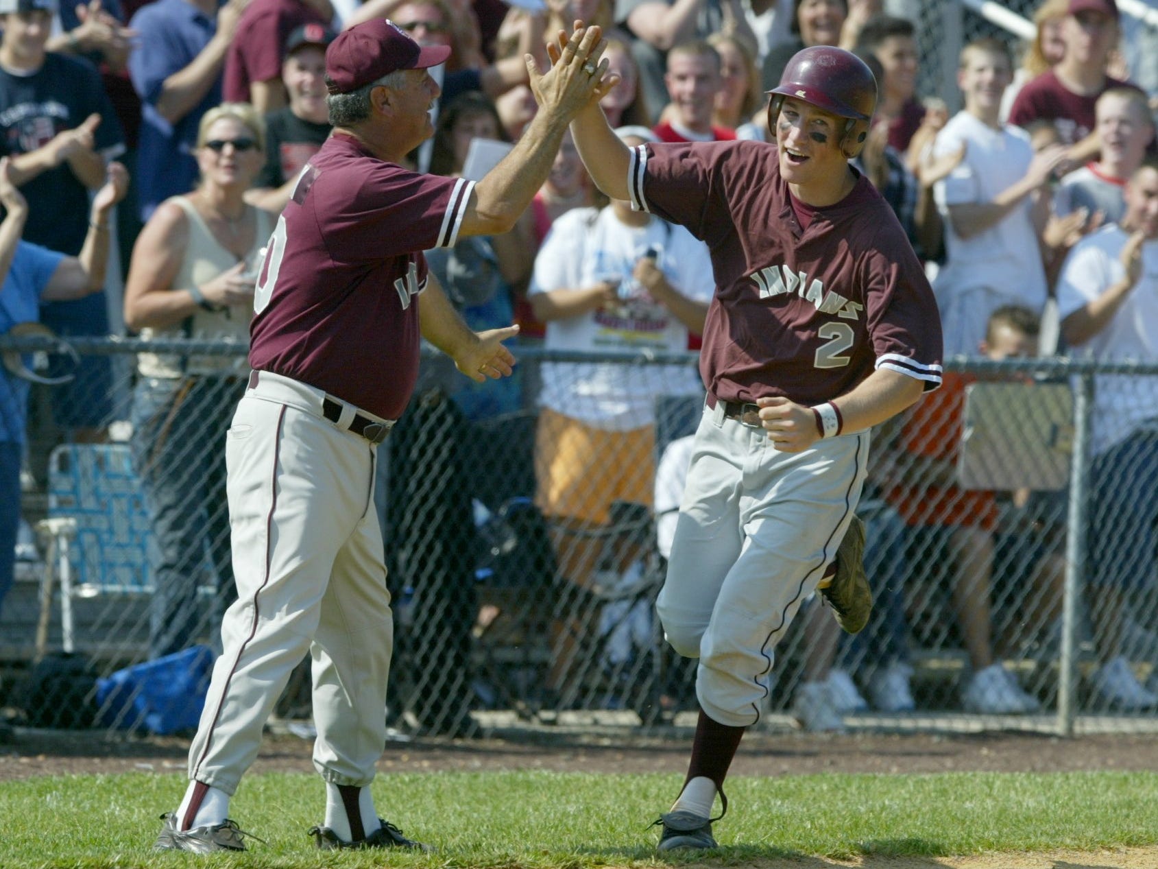 Todd Frazier celebrates with coach Ken Frank as he rounds third after ripping a home run against Cranford in 2003.