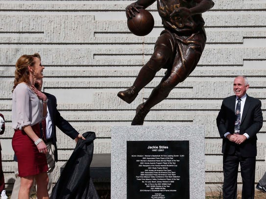 Jackie Stiles, left, sees her statue for the first