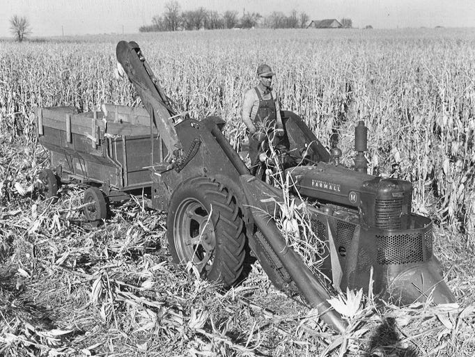 Clarence Gibbons of Polk City operates a two-row mounted corn picker on the Morris Alleman farm near Sheldahl. Gibbons planned to pick 600 to 700 acres of corn in 1943.