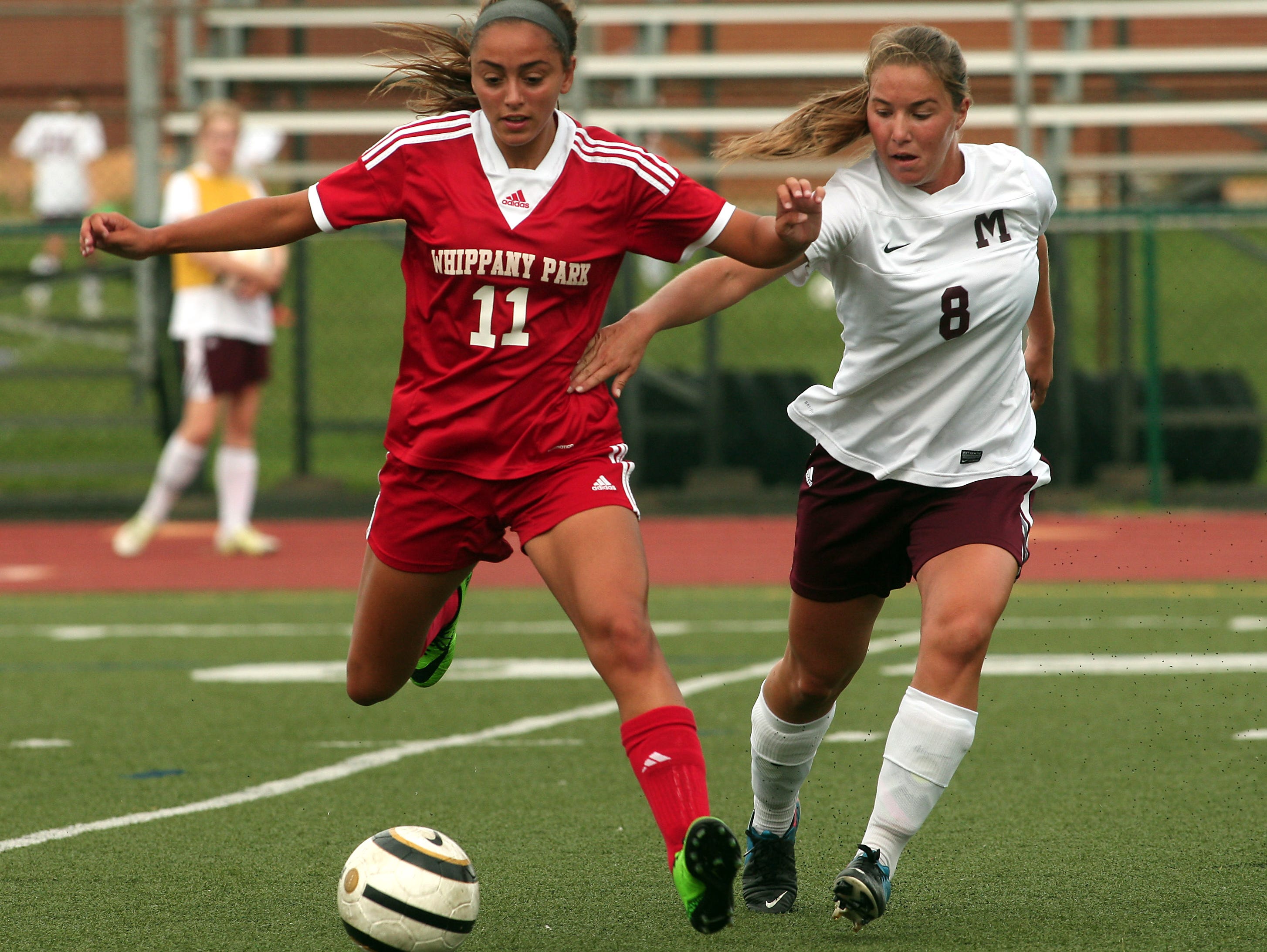 Whippany Park's Silvana Poulter and Madison's Megan Dyer battle for the ball during their girls soccer matchup. September 22, 2015, Madison, NJ.