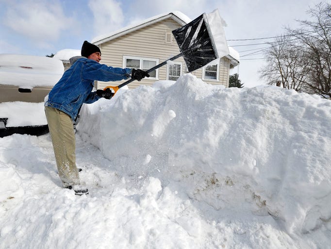 Allen Millette adds to the growing pile of snow in