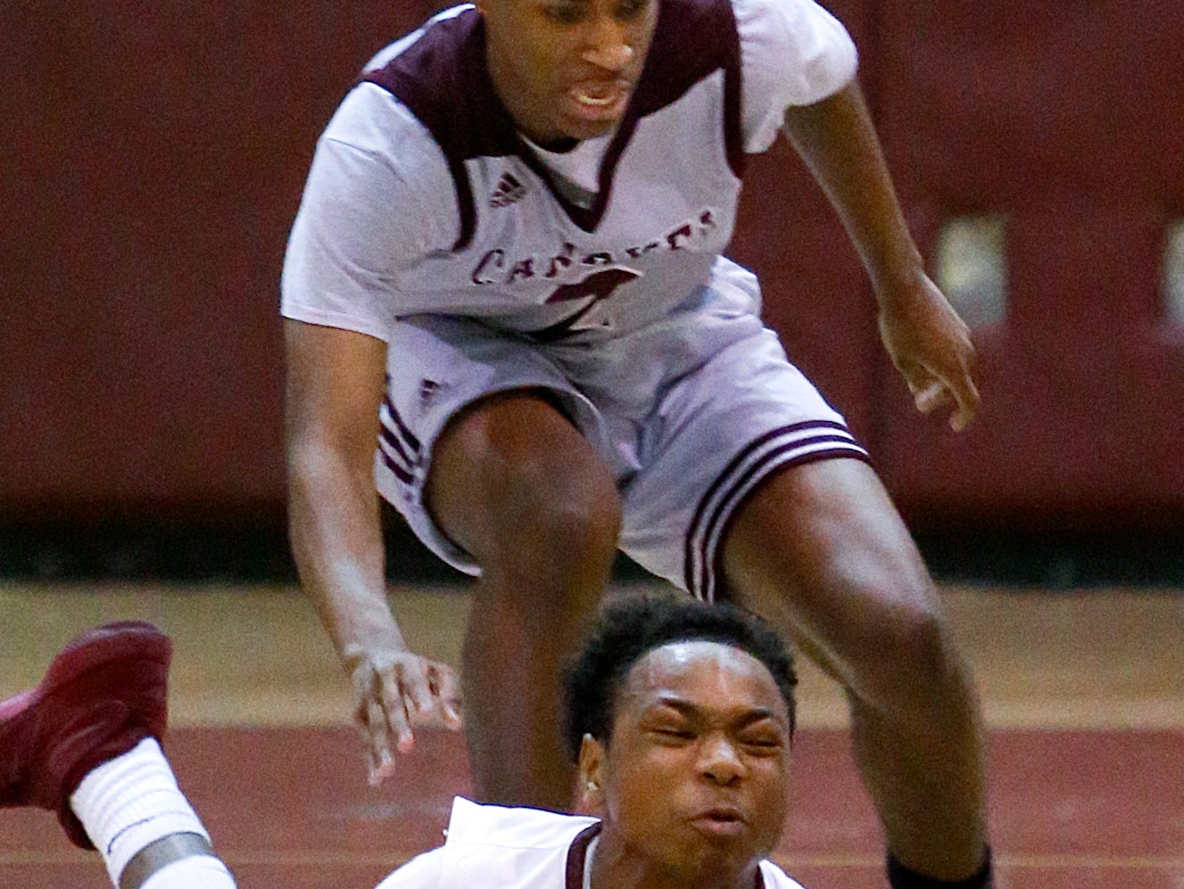 Caravel's Trevon Alderman (top) moves for a loose ball that Hodgson's Keenan Williams tries to gather in during the first half of the Bucs' 46-40 win at Hodgson in the opening round of the DIAA state tournament Wednesday