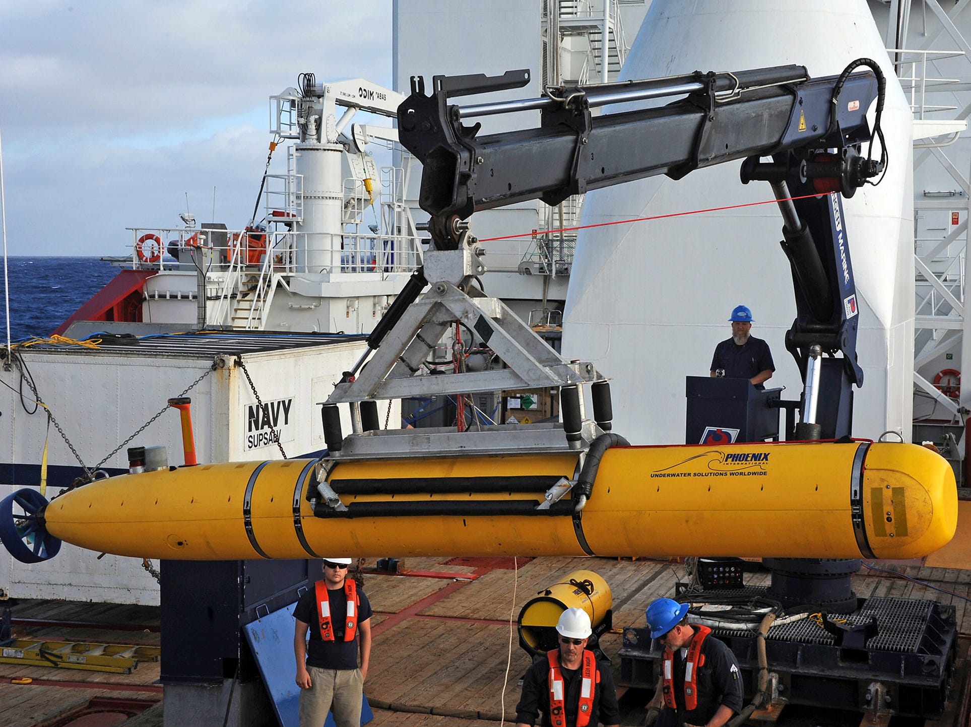 A photograph released on April 15 shows operators aboard the ADF Ocean Shield prepare to launch a U.S. Navy Bluefin-21 robotic submarine to search for the missing Malaysia Airlines jet in the Indian Ocean.