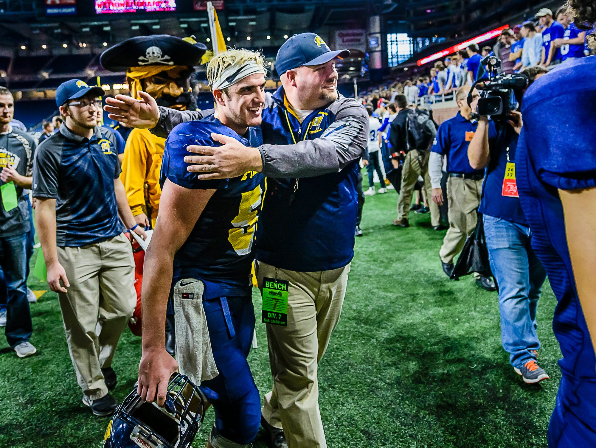 Pewamo-Westphalia Head Football Coach Jeremy Miller celebrates with senior lineman Devon Pung as they walk off the field after their Division 7 state final win over Detroit Loyola Saturday November 26, 2016 at Ford Field in Detroit.