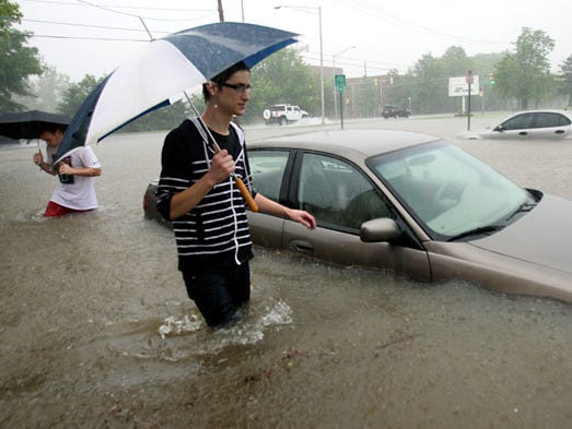 Ryan Clark, front, a TSU student, looks at the cars