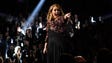 Adele reacts on stage.