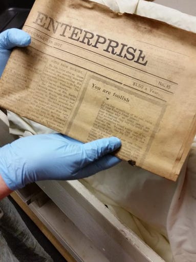 An archivist at the Western Regional Archives holds